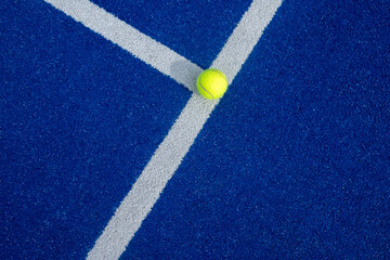 Fototapeta na wymiar Paddle tennis ball on a paddle tennis court for background