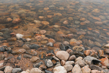 Transparent water in the reservoir, you can see the rocky bottom