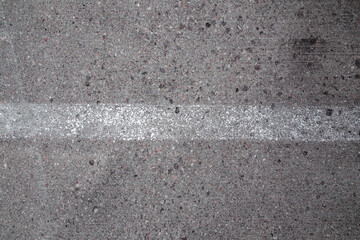 Fototapeta premium Real Rough Grey Grunge Concrete Asphalt Wall Backdrop Texture with Rocks and White Painted Stripe