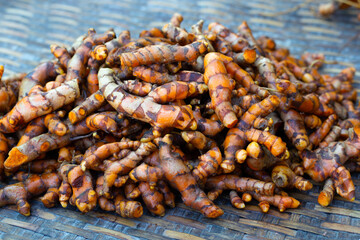 Fresh turmeric roots on bamboo plate