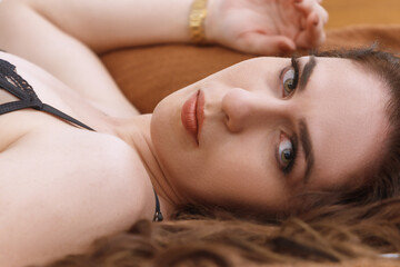 Obraz na płótnie Canvas Cute Caucasian girl, blonde hair, wearing lingerie in a hotel room, sensualizing in a photo shoot