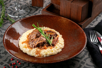 Milanese risotto with beef stew. Italian cuisine dish with rice and beef meat in sauce