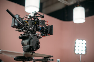 A professional film and video camera on the set. Filming day, equipment and crew. Technique of...