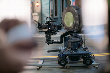 Fototapeta premium A professional film and video camera on the set. Filming day, equipment and crew. Technique of modern video filming.