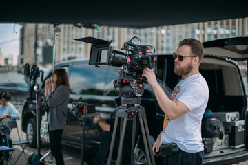 Director of photography with a camera in his hands on the set. Professional videographer at work on...