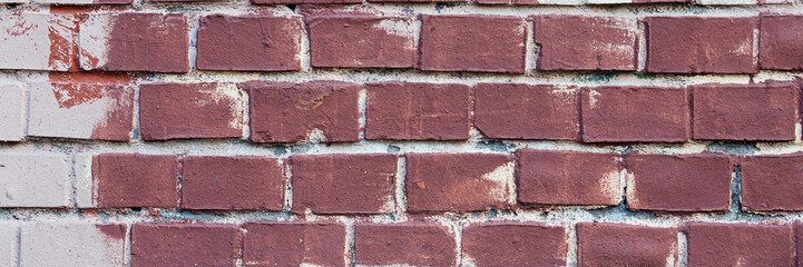 Old painted brick wall. Texture of rough brickwork. Wide panoramic background with masonry.