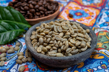 Green and roasted coffee beans from South America coffee producing region, from Colombia and Brazil with  mountain ranges and climate ideal for coffee growing