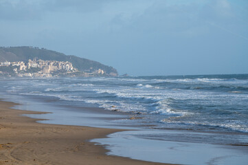 Water sport at cold winter water of Tyrrhenian sea between two touristic towns Sperlonga and Terracina in Lazio, Italy