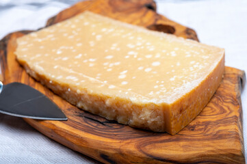 72 months very old Italian parmigiano-reggiano parmesan cheese from Parma has amber color, dry, extremely grainy and crumbly with very intense taste.