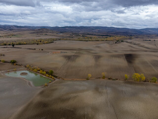 Aerial view on hills of Tuscany, Italy. Tuscan landscape with ploughed fields in autumn.