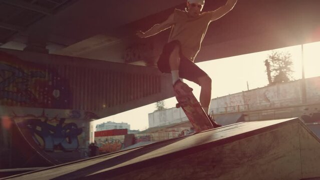 Young skater performing trick on skate board skate skate. Hipster skateboarding