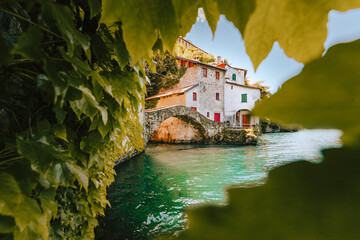 Village of Nesso with the medieval bridge, also called Civera bridge, on Lake Como. Orrido of Nesso