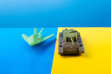 military war plane, fighter plane  and tank the background of the Ukrainian flag. The concept of...