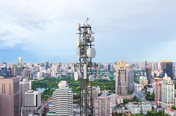 Telecommunication tower with 5G cellular network antenna on city background