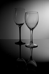 Glass wine glasses, on a black and white background.