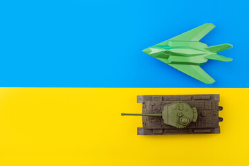military war plane, fighter plane  and tank the background of the Ukrainian flag. The concept of...