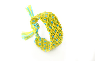 Woven DIY friendship bracelets handmade of embroidery bright thread with knots on white background