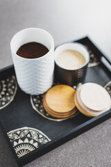 sugar and coffee canisters on boho breakfast tray, concept of organised minimalist kitchen