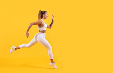 Fototapeta na wymiar sport girl runner running on yellow background. copy space