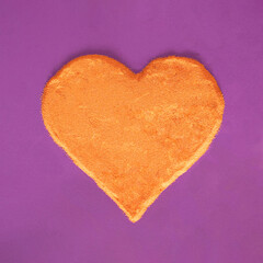 Sunny orange heart against purple background . Minimal creative concept.