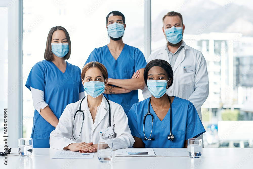 Wall mural Teamwork allows us to cut down on medical errors. Portrait of a group of medical practitioners having a meeting in a hospital boardroom.