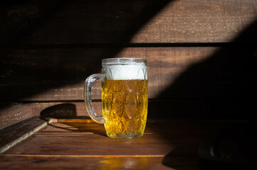 glass of beer on wooden table