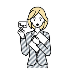 立って書類とカードを手に持つスーツの女性