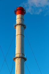 Chimneys of the power plant against the sky.
