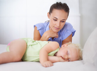 Sleep my little angel. Shot of a mother watching over her sleeping child.