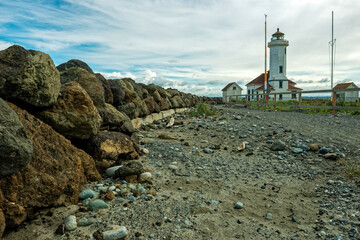 Fototapeta na wymiar A rocky path leads to the Point Wilson Lighthouse in Fort Worden State Park, Washington, USA
