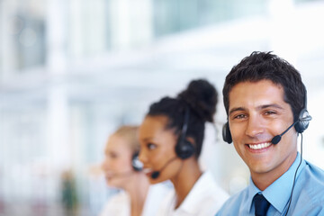 Customer service representative. Portrait of smart male operator on call with female colleagues.