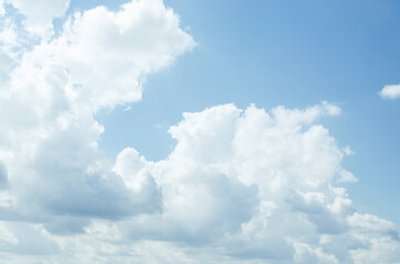Plakat White air cumulus clouds in a blue sky. Summer background