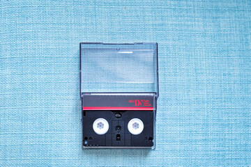 Mini DV digital cassette tape isolated on cyan blue background
