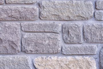 Close up of rough textured grey brick wall background. Decorative design element background.