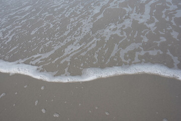 the edge of a calm wave at the beach