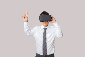 Studio portrait businessman wearing VR Headset touching something.