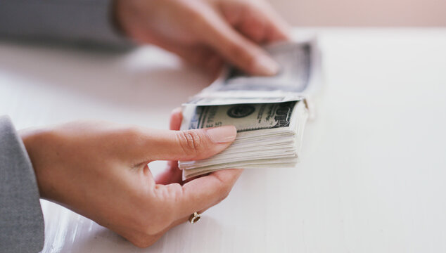 Shes earned this moola. Cropped shot of an unrecognizable businesswoman counting a stack of money in her office during the day.