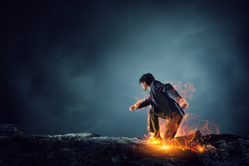 Obraz premium Determined businessman leaving fire trails on asphalt