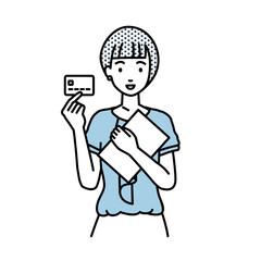 立って書類とカードを手に持つオフィスカジュアルの女性