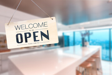 Wooden sign board hanging on door of cafe,Come in we're open, vintage black retro sign in blurred backgroundl, copy space for text.