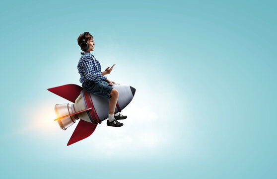 Kid wearing headphones on a rocket