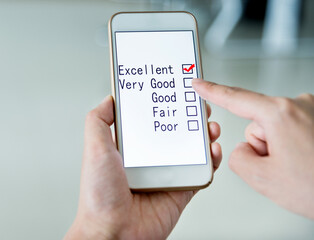 Hand holding smartphone with customer service survey form on screen