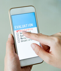 Hand holding smartphone with customer service survey form on screen