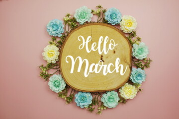 Hello March typography text decorate with flower on pink background