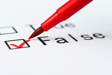 Tick boxes for True or False on paper with pen