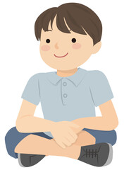 A boy sitting on the ground with crossed legs