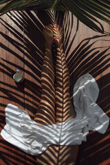 Fototapeta na wymiar Cropped image of woman in spa with palm leaves reflection on body
