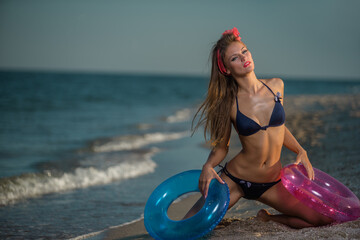 Girl wearing  bikini with lifebuoy on beach