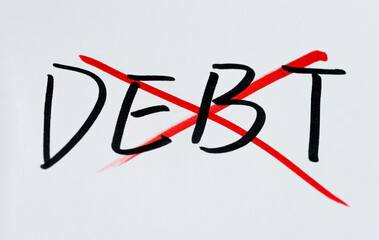 Drawing cross on word debt from white paper