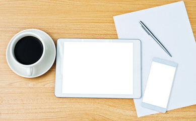 Obraz na płótnie Canvas Digital tablet smartphone and a cup of coffee on the desk